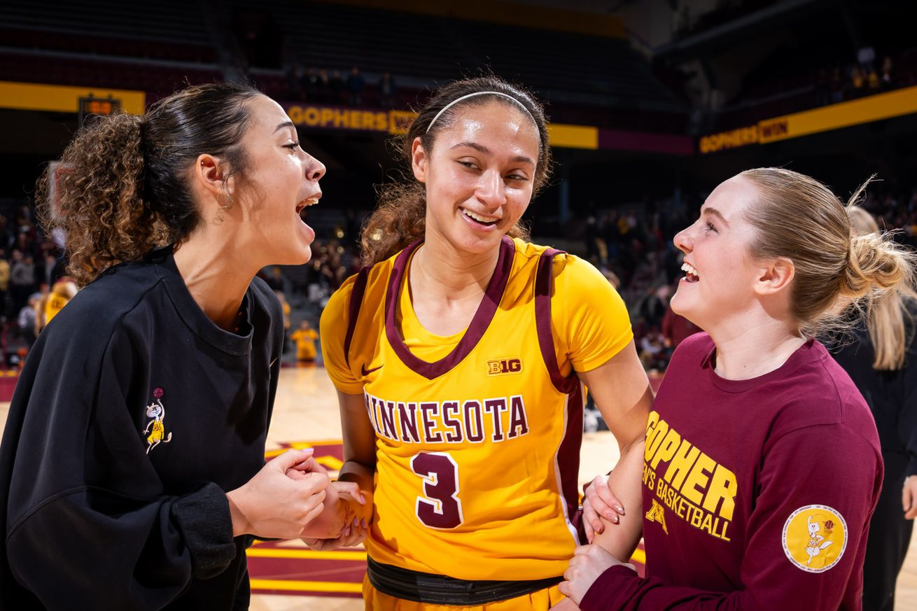 Amaya Battle celebrates with teammates Kennedy Klick and Brynn Senden after beating Nebraska