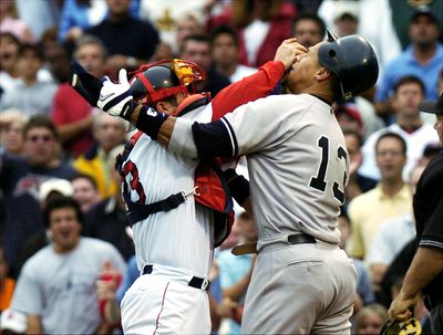 Boston Red Sox’s catcher Jason Varitek (left) pushes New Yor