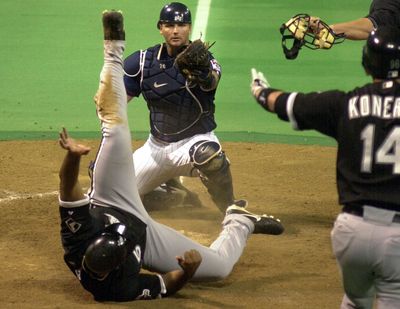 David 83838 9/16/03 Twins vs White Sox------ Twins catcher A.J. Pierzynski watches White Sox Carlos Lee tumble across the plate Tuesday night for a run in the 6th inning during American league central division action at the dome against the Chicago White