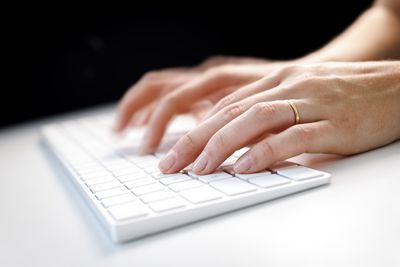 Hands Typing On Keyboard